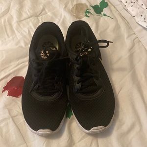 Black and gold Nike sneakers size 10